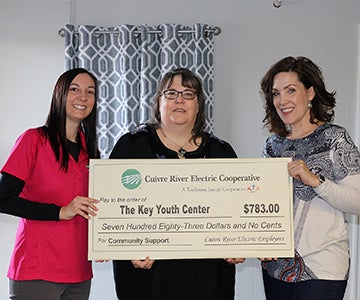 Cuivre employee presents donation to local youth center