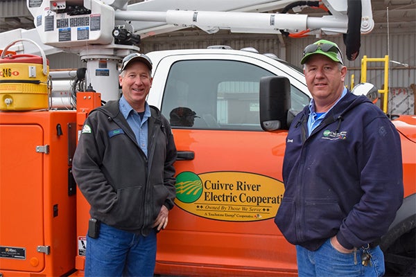 Cuivre River employees stand in front of a truck