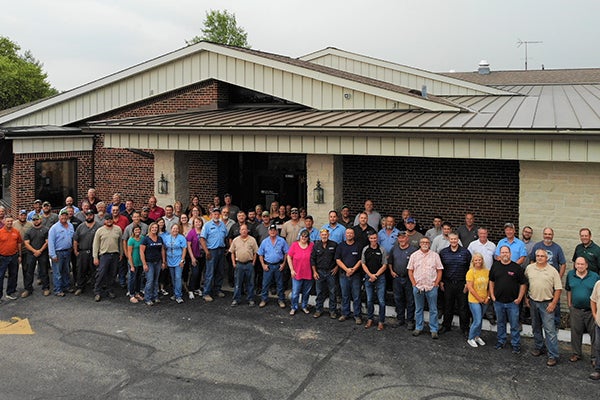 Cuivre River employees at our Troy location pose in front of our old headquarters before it is torn down.