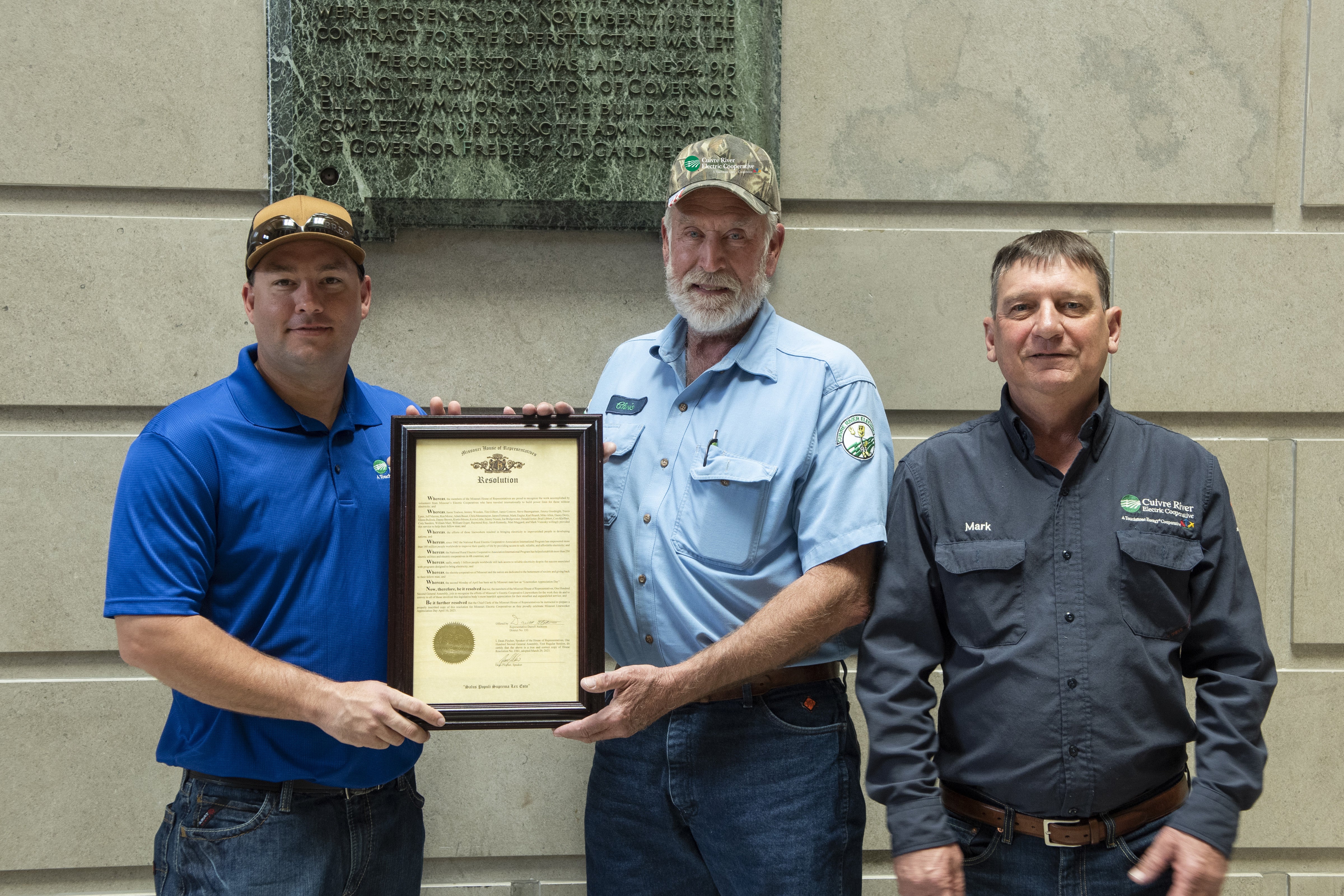 From left, James Fortman, Chris Mennemeyer and Mark Ziegler with the Missouri legislature resolution recognizing their international volunteer service in NRECA’s International Program.