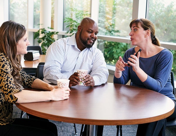 People sit around a table and drink coffee